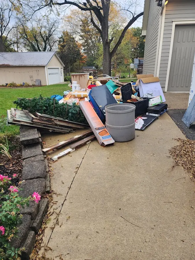 Dumpster being loaded with debris for Roofing Dumpster Rental in Bowie